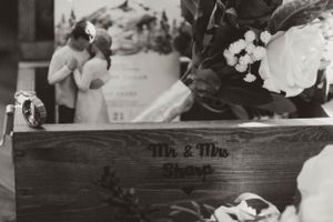 Black and white photo of decorative wooden box with Mr. & Mrs. text and flowers.
