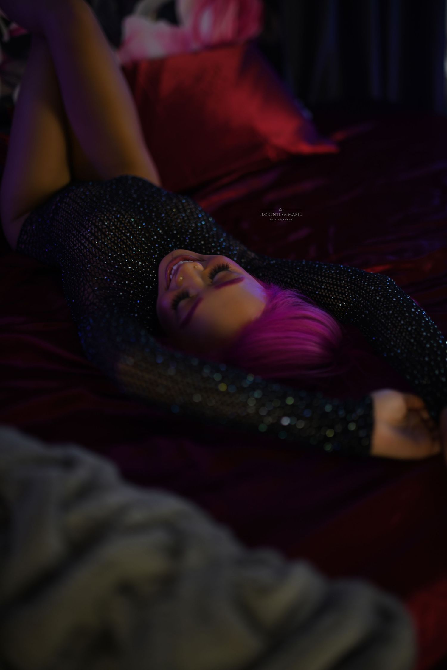 Dark moody nightclub scene with pink and red lighting creating a dramatic atmospheric ambiance.