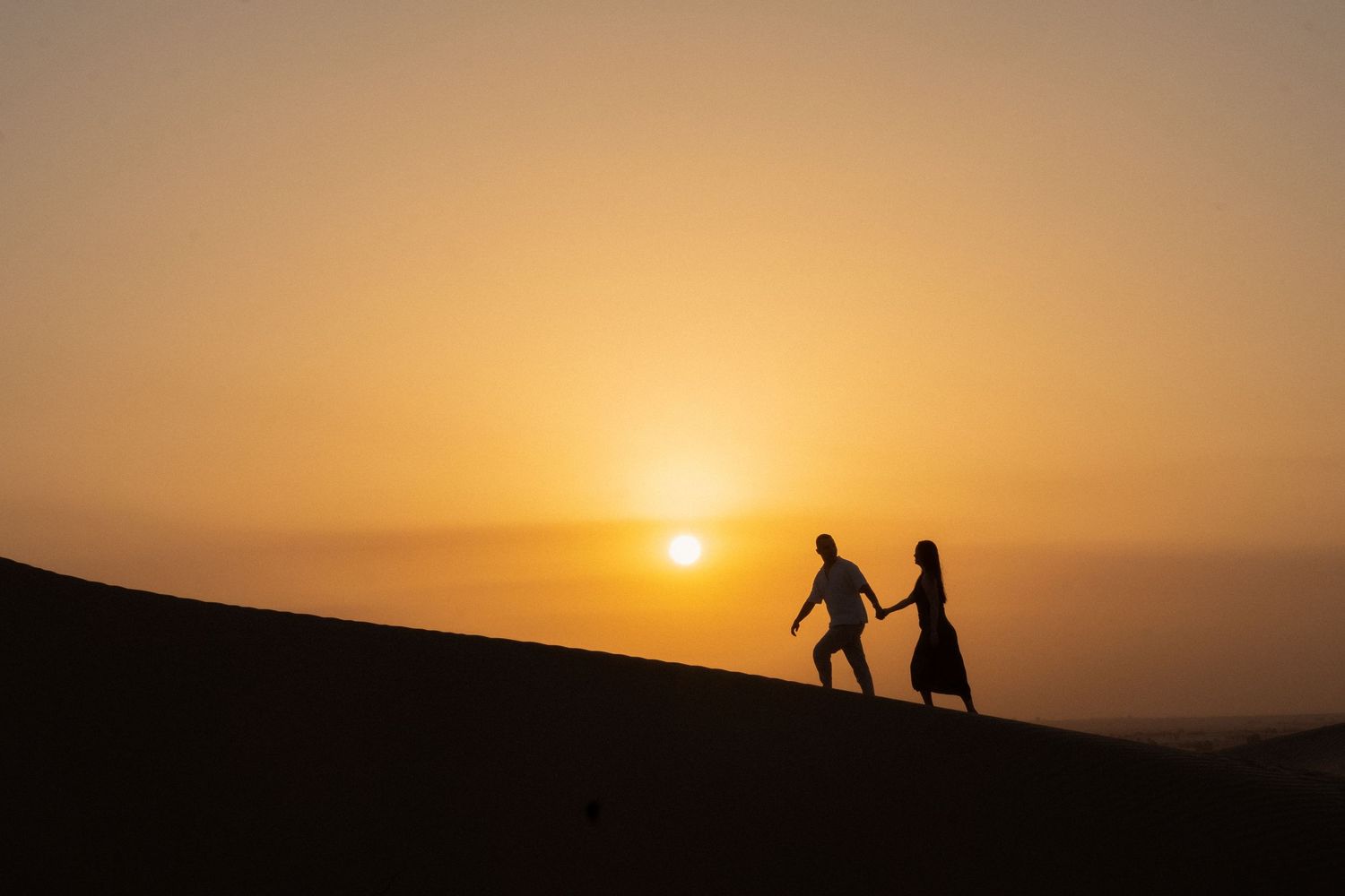 Pre-wedding photoshoot in Dubai desert – couple silhouette at sunset