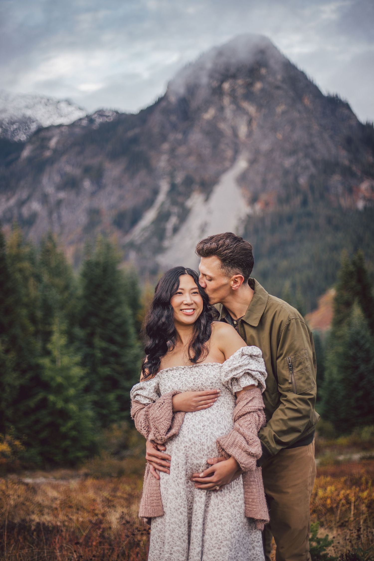 Couple snuggling together during their adventure maternity photography session in Snoqualmie, Washington