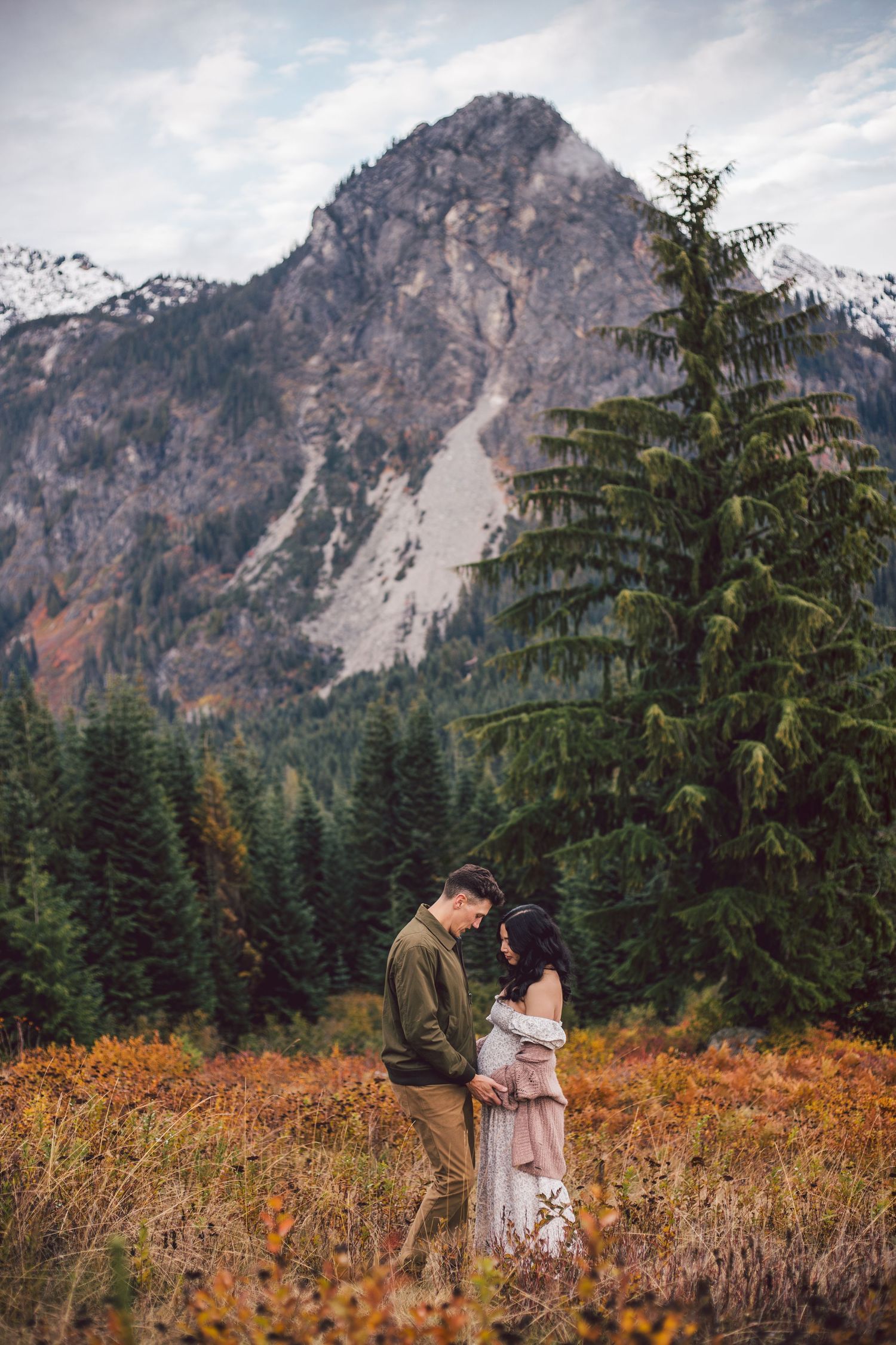 Couple snuggling together during their adventure Seattle maternity session in Snoqualmie, Washington