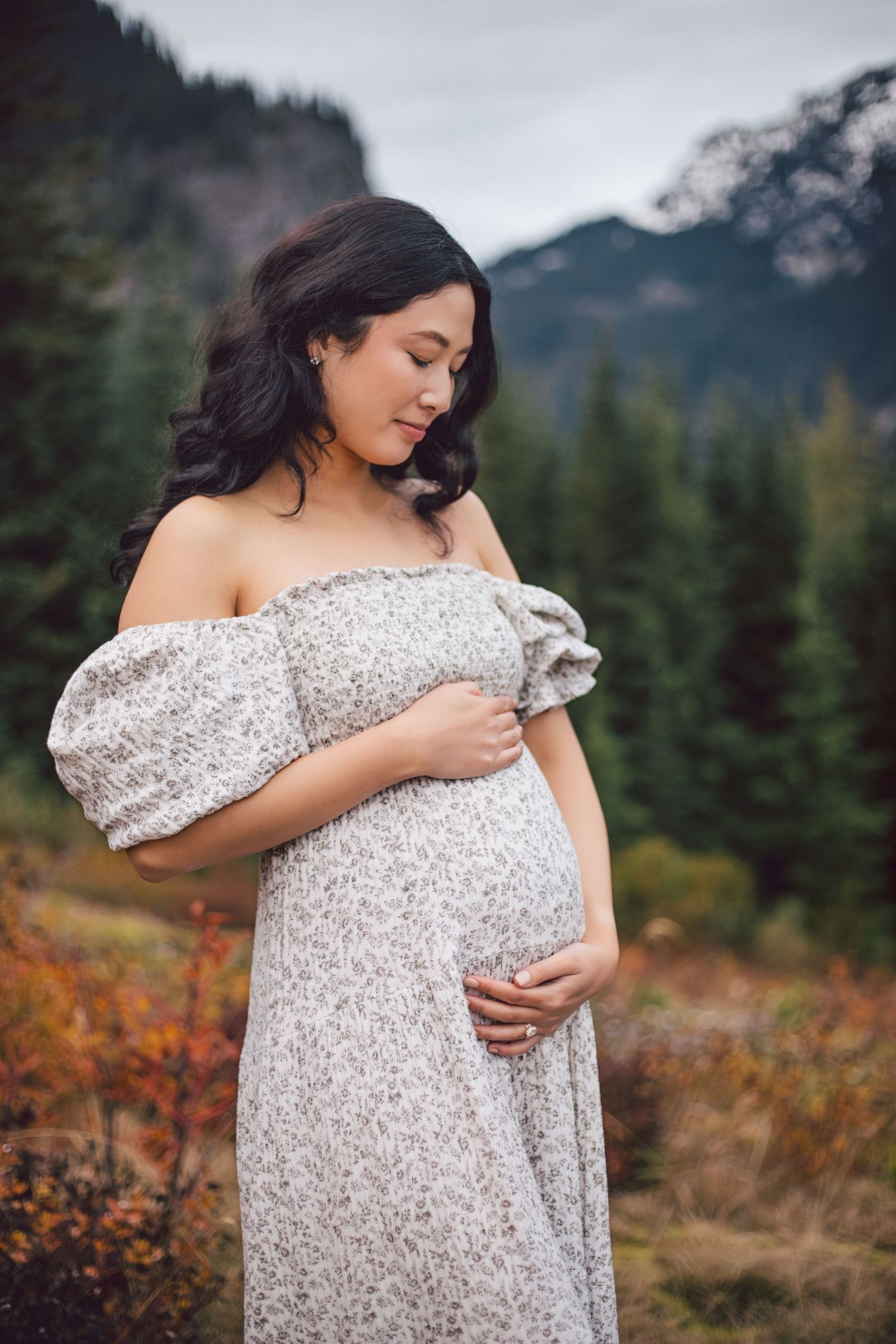 Mom holding baby bump during maternity photos in Snoqualmie, Washington