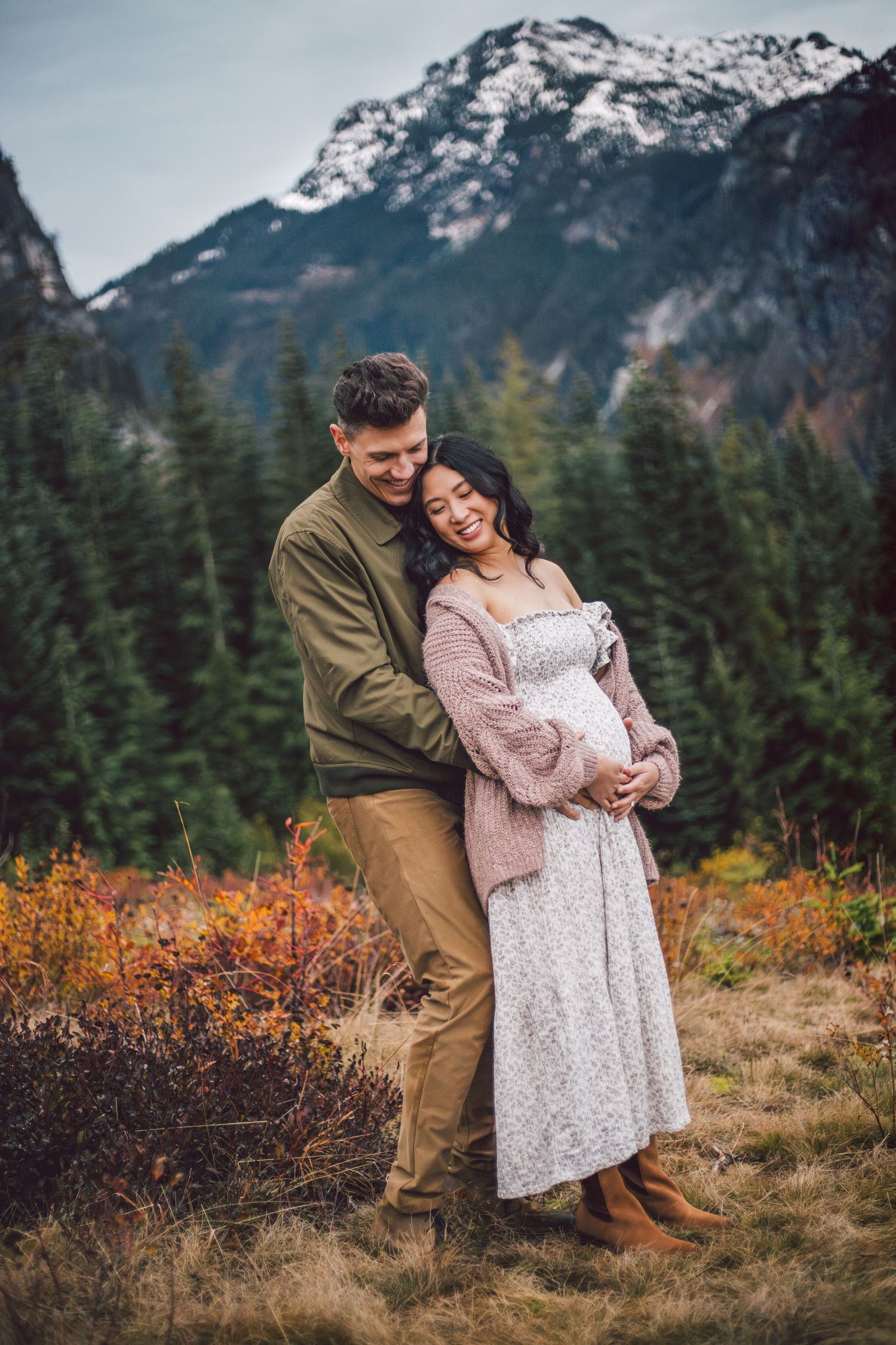 Couple snuggling together during their adventure maternity photos in Snoqualmie, Washington