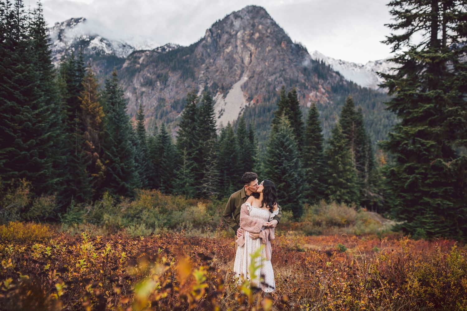 Couple kissing together during their adventure maternity photos in Snoqualmie, Washington