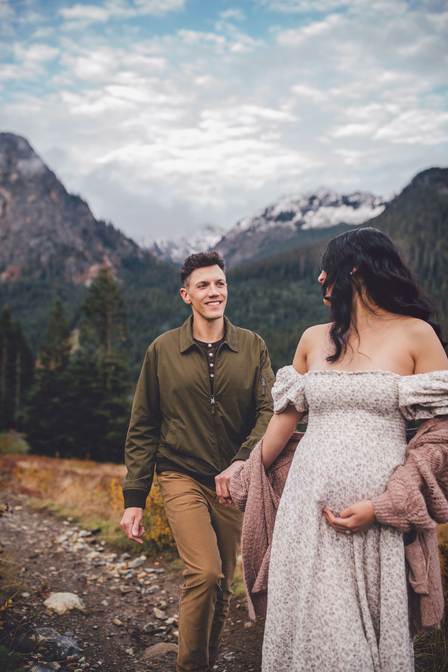 Couple smiling together during their adventure maternity photos in Snoqualmie, Washington