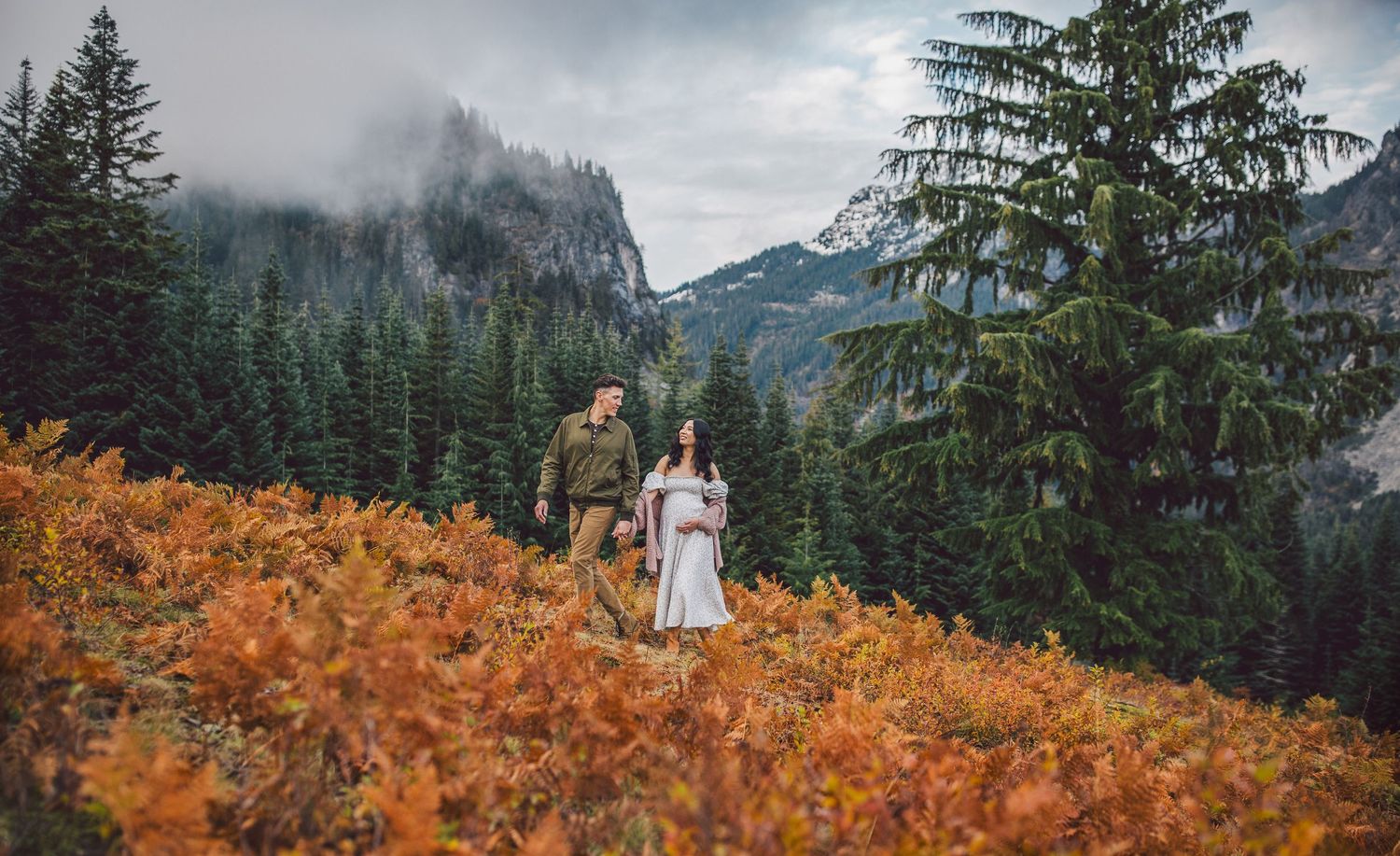 Couple walking together and during their adventure maternity photos in Snoqualmie, Washington