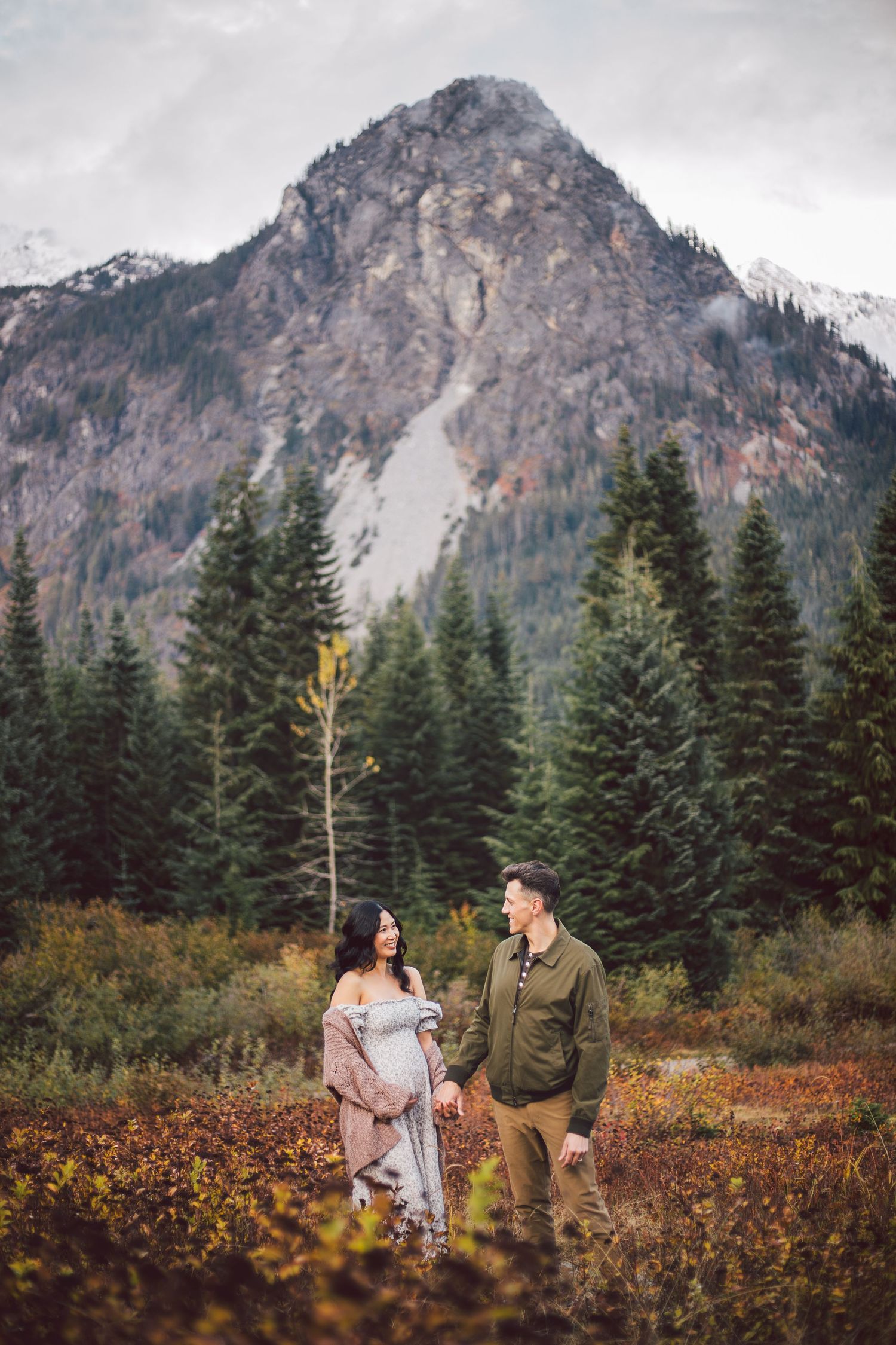 Couple holding hands together during their adventure maternity photos in Snoqualmie, Washington