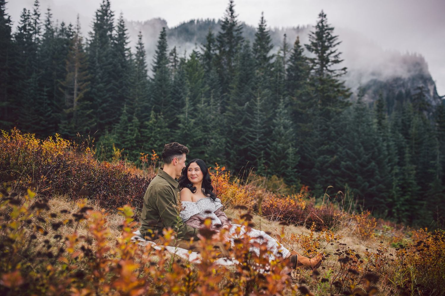 Adventurous couple snuggling together during their adventure maternity photos in Snoqualmie, Washington