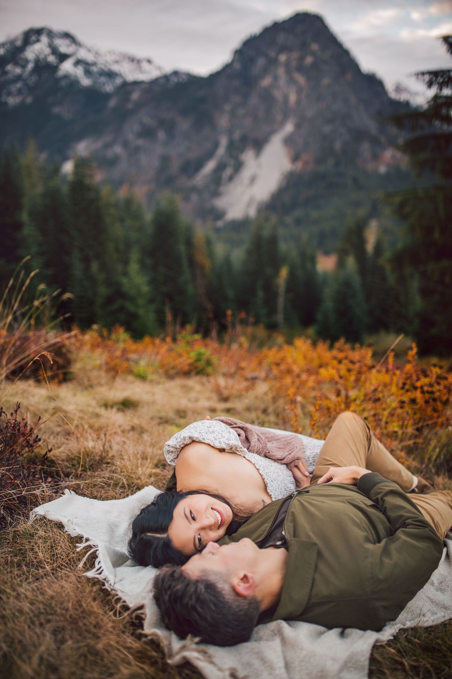 Adventurous couple snuggling together during their adventure maternity photos in Snoqualmie, Washington