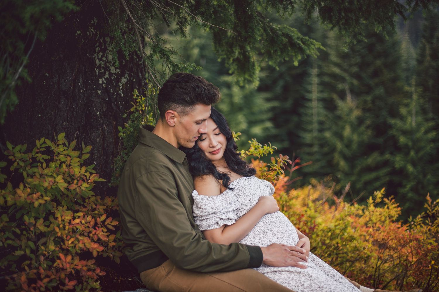 Couple snuggling together during their adventure maternity photo shoot in Snoqualmie, Washington