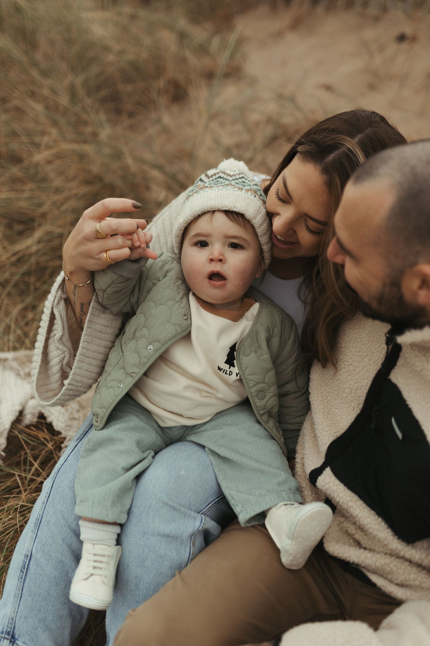 A series of intimate outdoor portraits showing tender moments between parent and child in a natural setting.