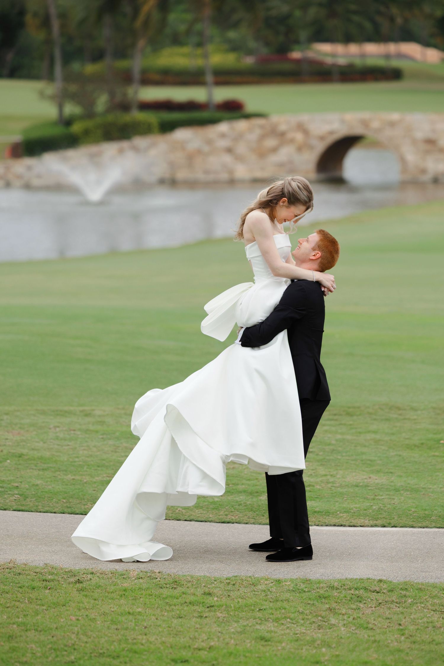 Groom lifts bride in excitement on their wedding day photographed by Tom Forrest Photography of Hudson, Ohio.