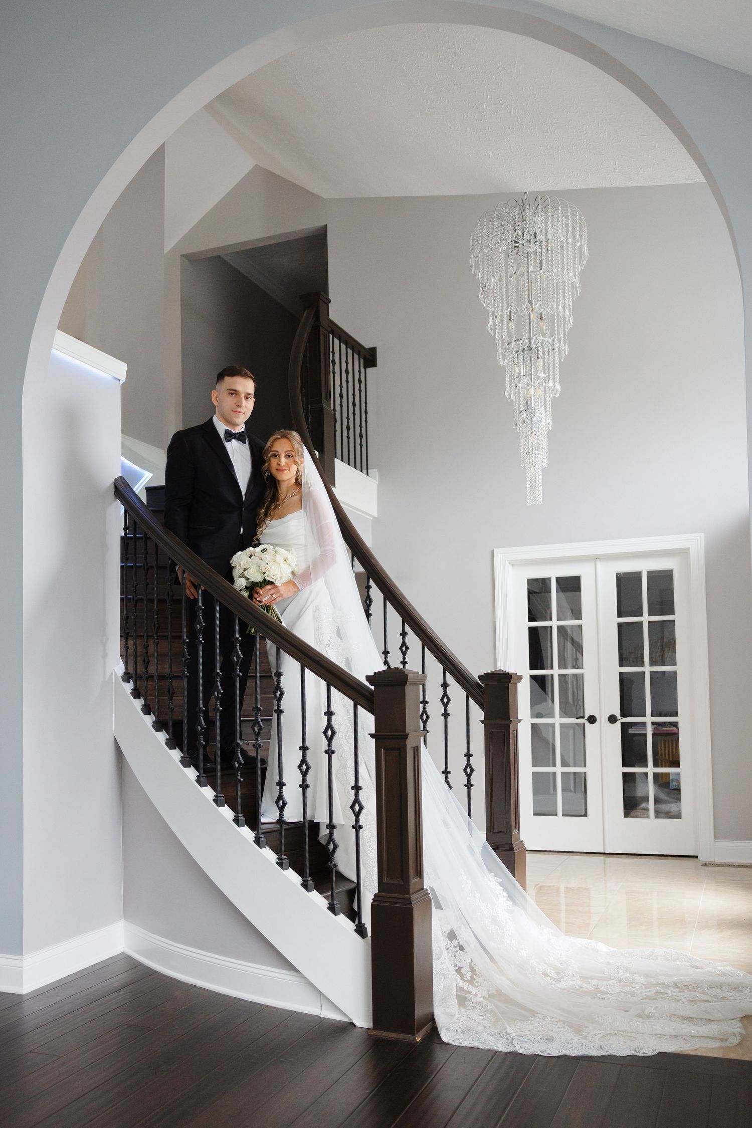 Bride and groom on staircase photographed by Tom Forrest Photography of Hudson, Ohio.