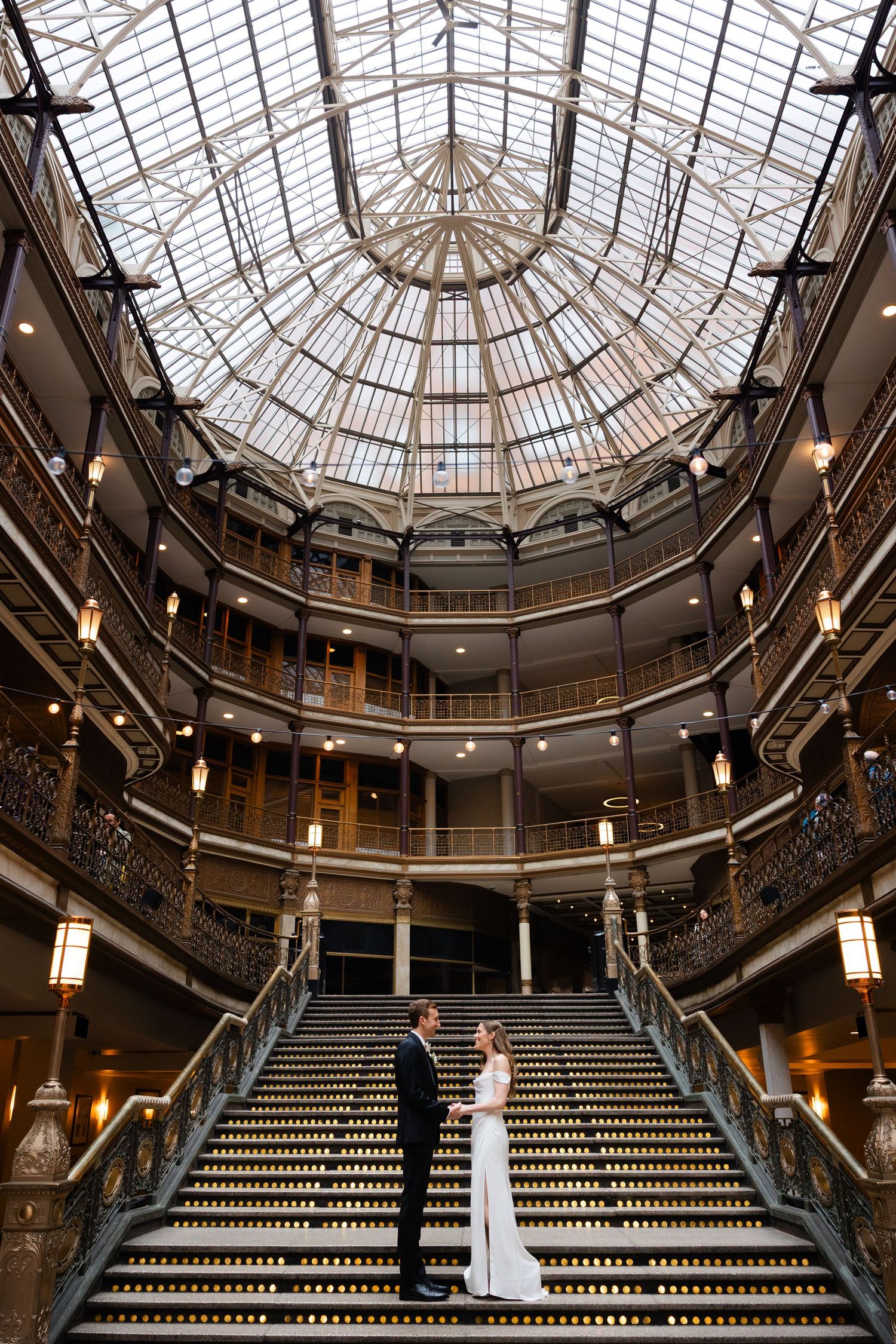 Bride and groom on stunning staircase at the Hyatt Arcade in downtown Cleveland photographed by Tom Forrest Photography of Hudson, Ohio.