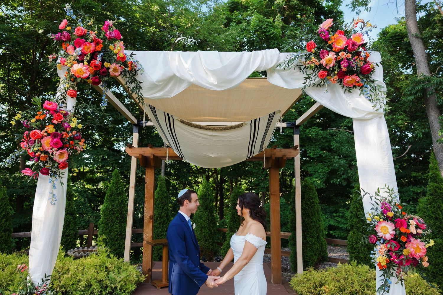 Bride and groom under chuppah during their wedding day at Tall Oaks East photographed by Tom Forrest Photography of Hudson, Ohio.