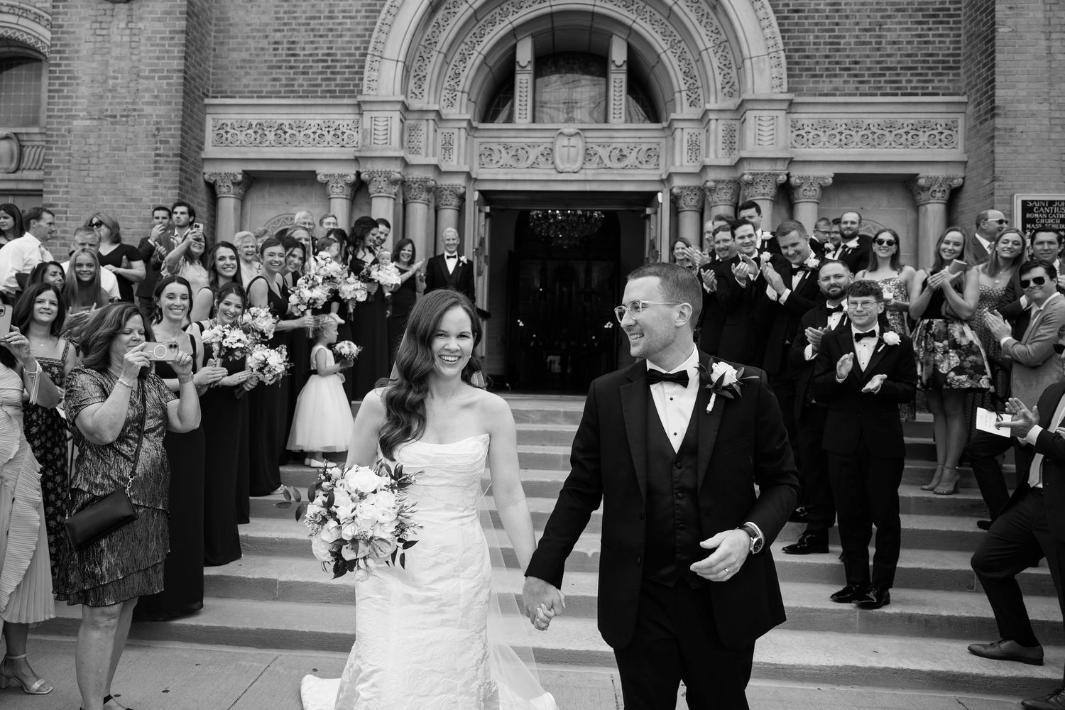 Couple leaving wedding ceremony in Cleveland  photographed by Tom Forrest Photography of Hudson, Ohio.