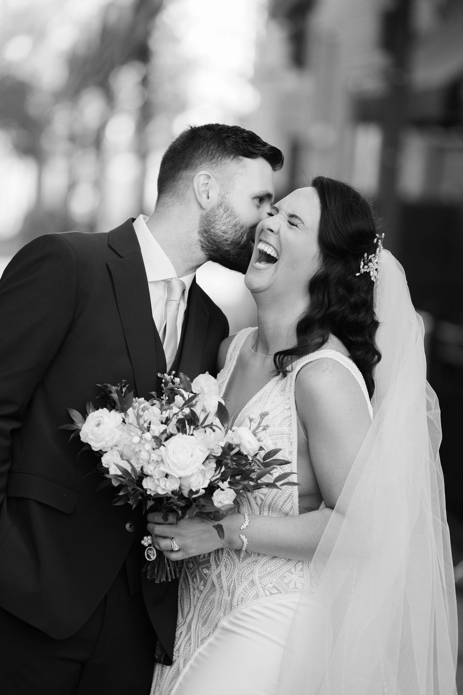 Bride and groom laughing outside Historic Onesto in Canton photographed by Tom Forrest Photography of Hudson, Ohio.