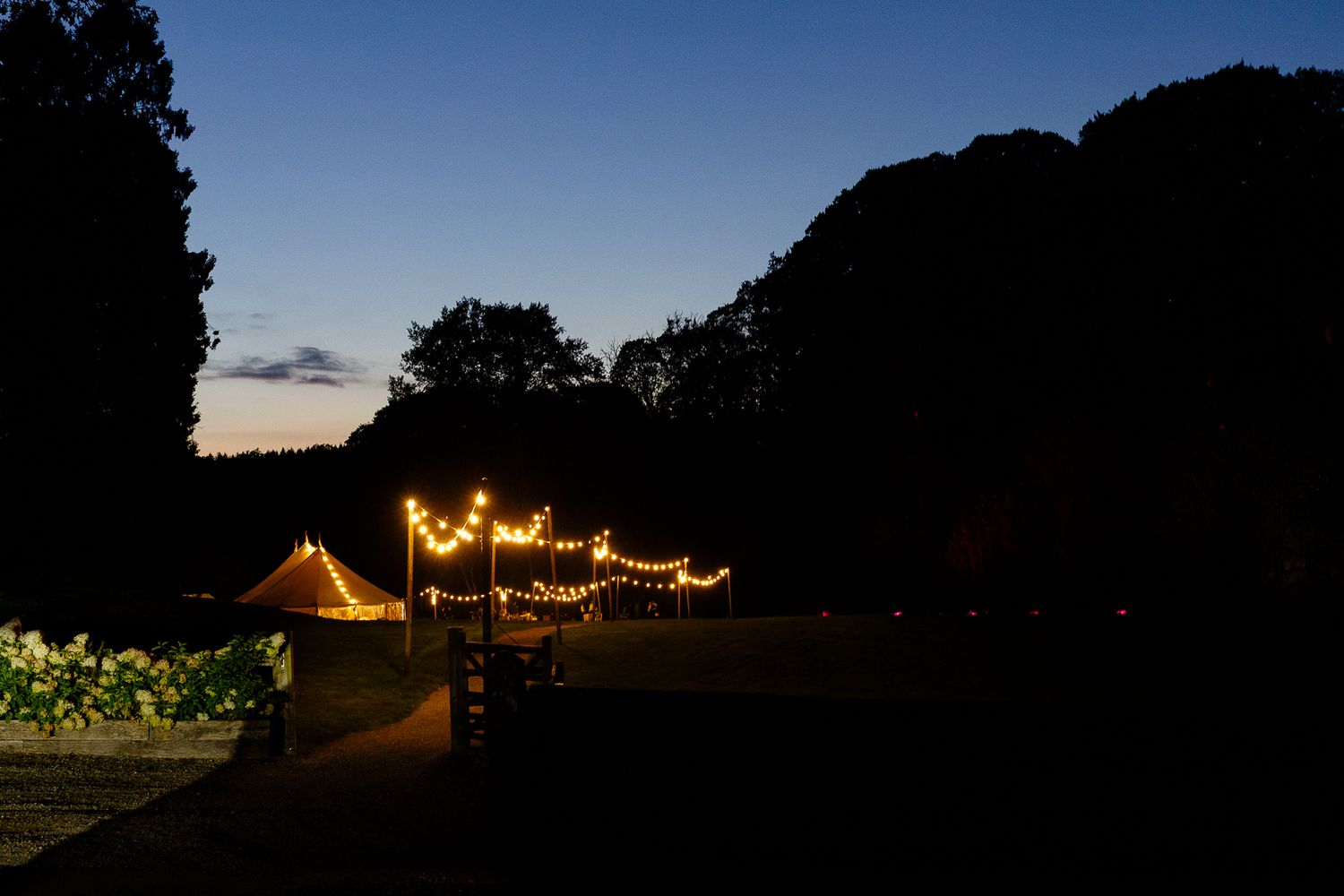 A series of nighttime camping scenes showing illuminated tents and outdoor spaces under dark skies.