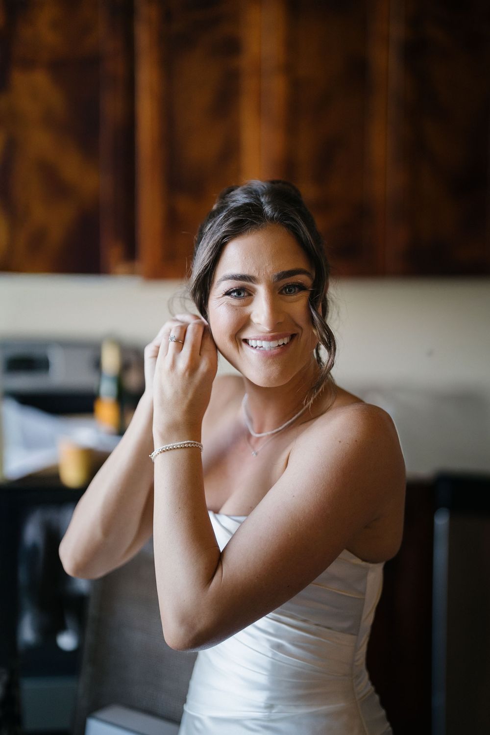A person in a white sleeveless top smiles while making playful poses in a sequence of candid shots.