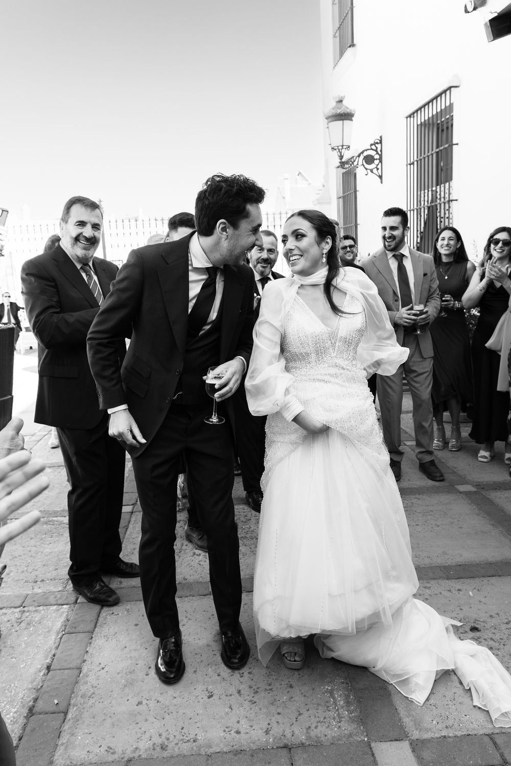 Black and white wedding sequence showing joyful dancing and celebration moments with guests.