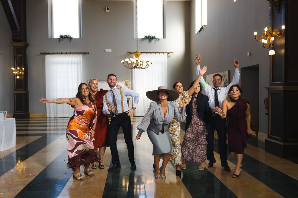 Wedding guests dance and celebrate together on an elegant dance floor during a reception celebration.