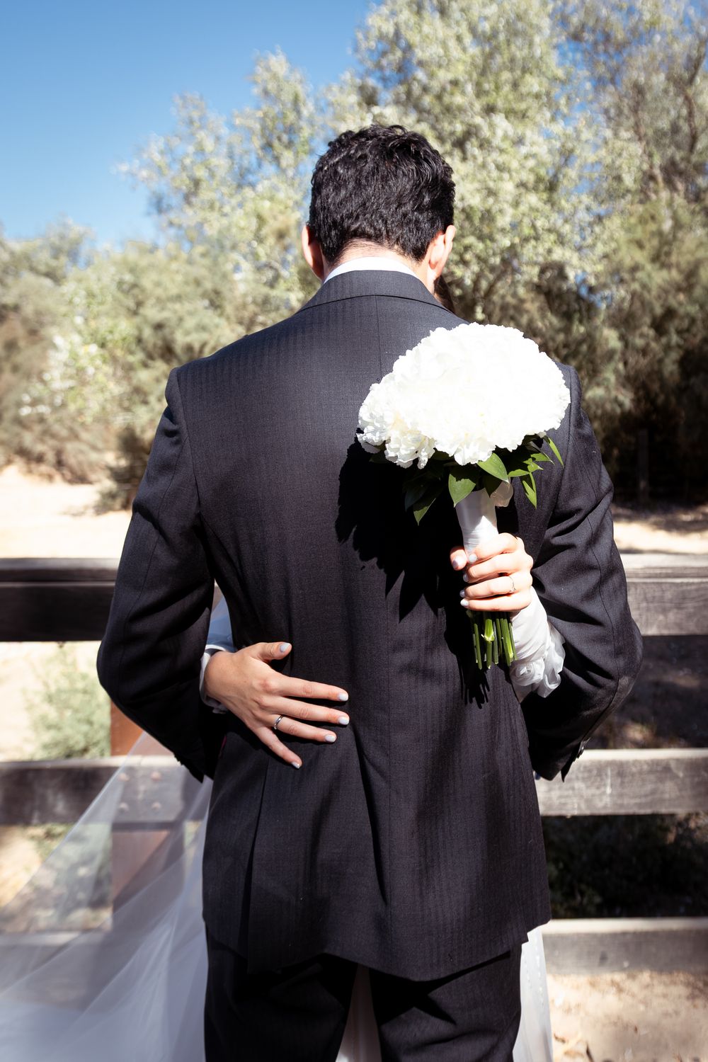 A series of photos showing a couple embracing at a wedding, with the bride holding a white bouquet against the groom's dark suit.