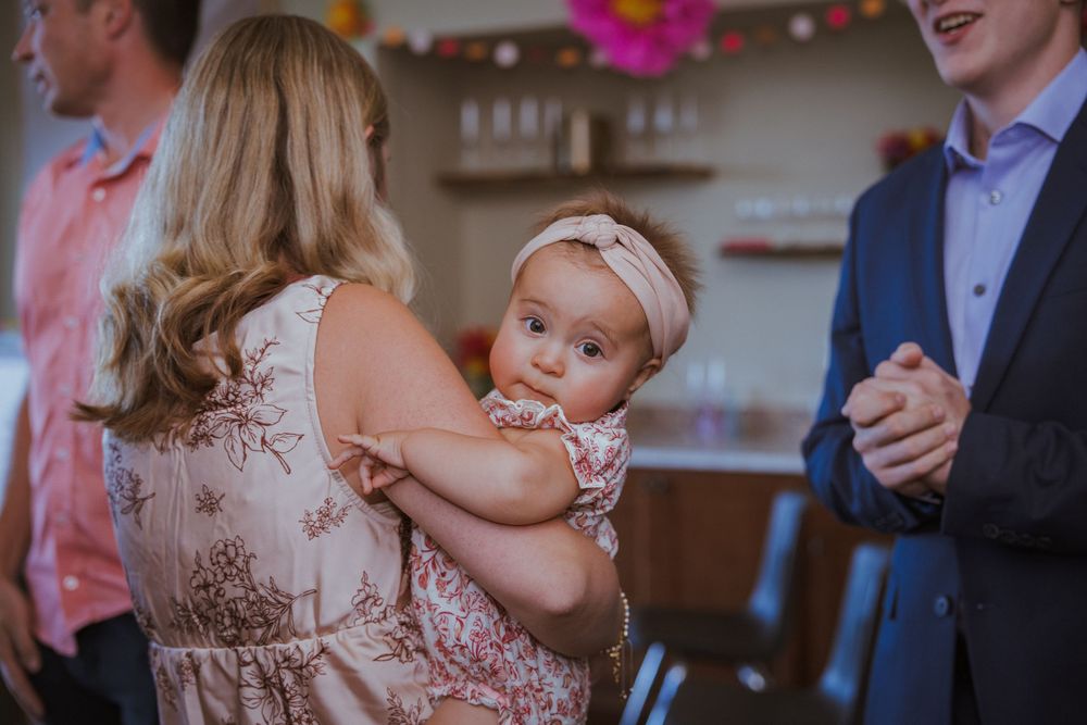Wedding reception guests enjoying drinks and socializing at a festive indoor celebration.