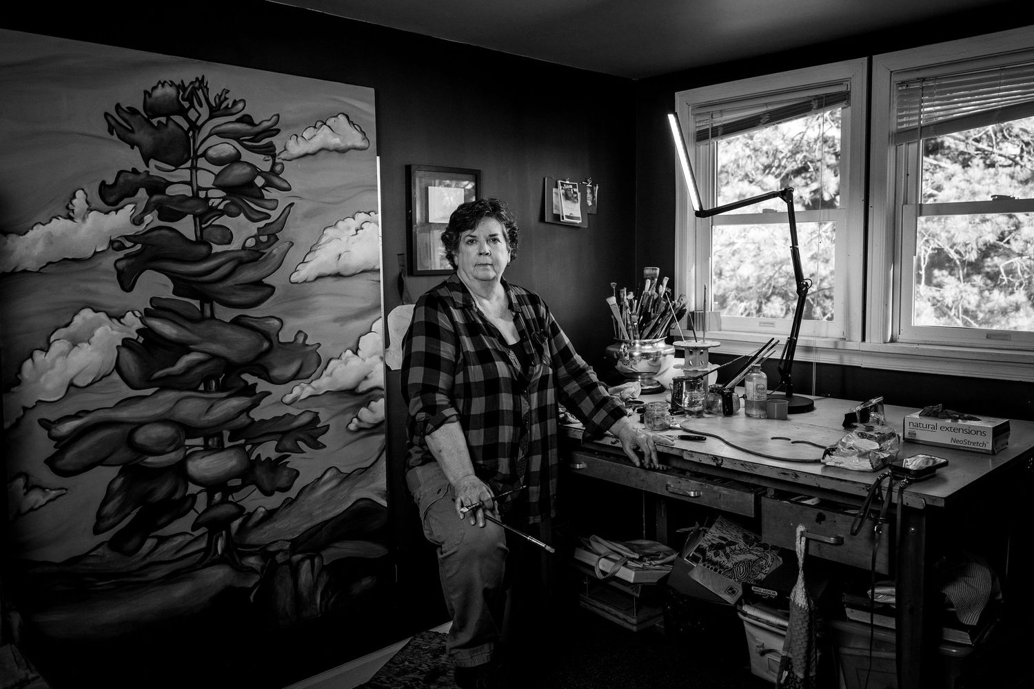 A black and white photo sequence shows someone working at a desk near a window in a creative workspace.