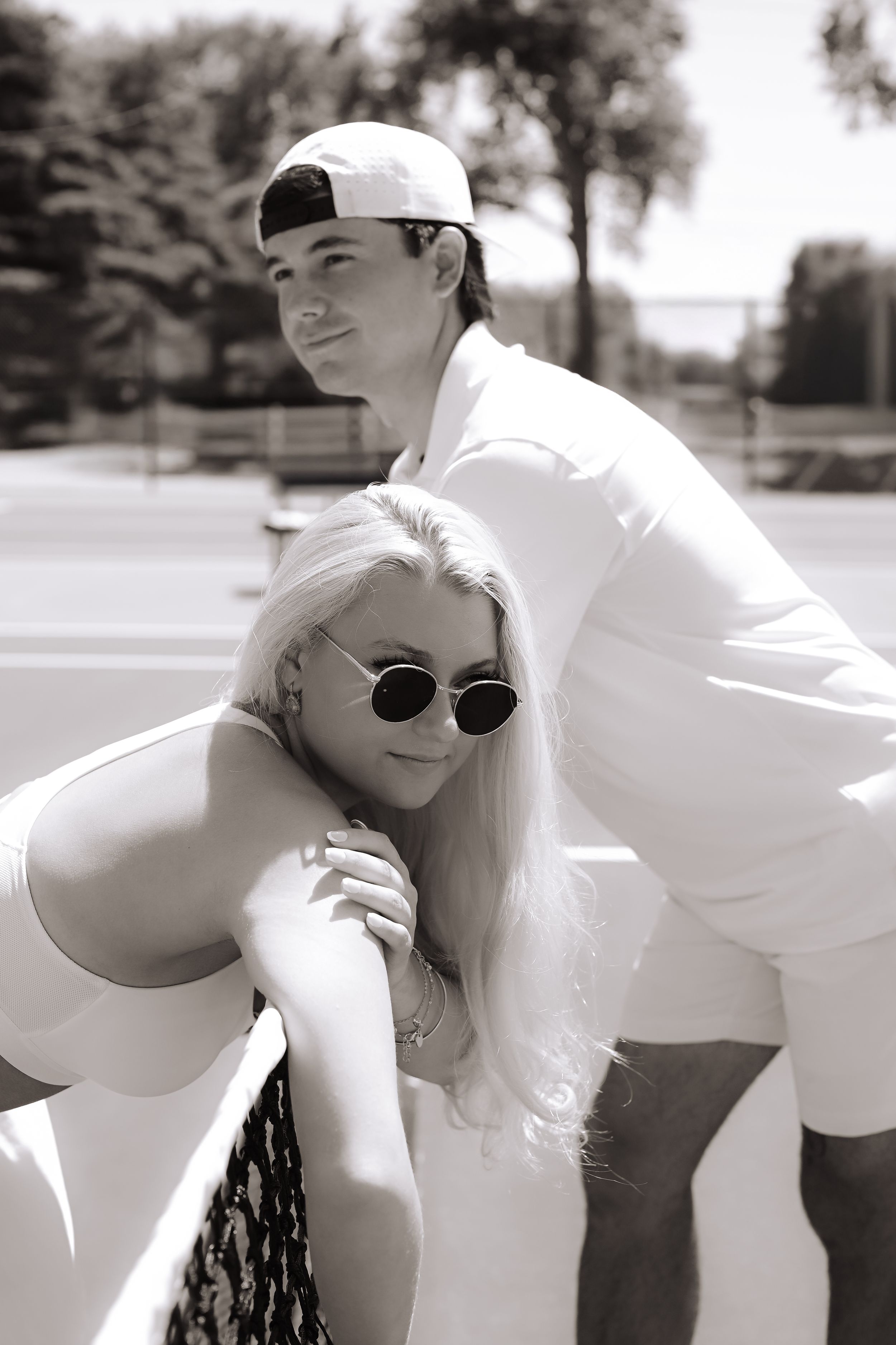A series of black and white artistic photos showing tender romantic moments between a couple outdoors.