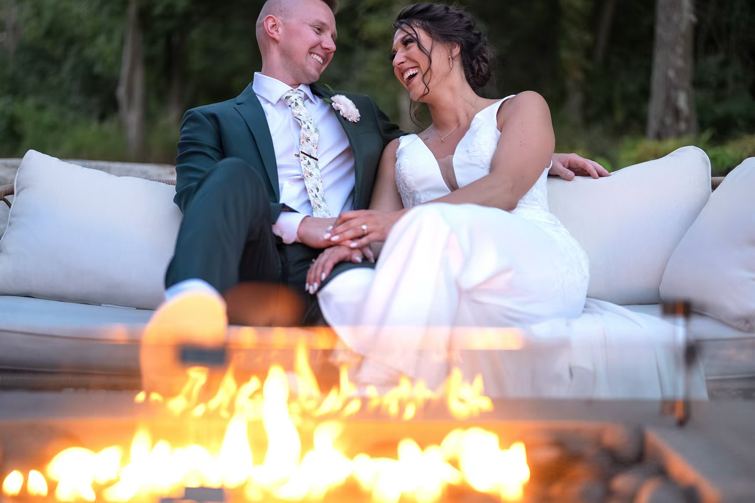 a couple enjoying time next to a cosy flame in Retreat 21 Wedding Venue
