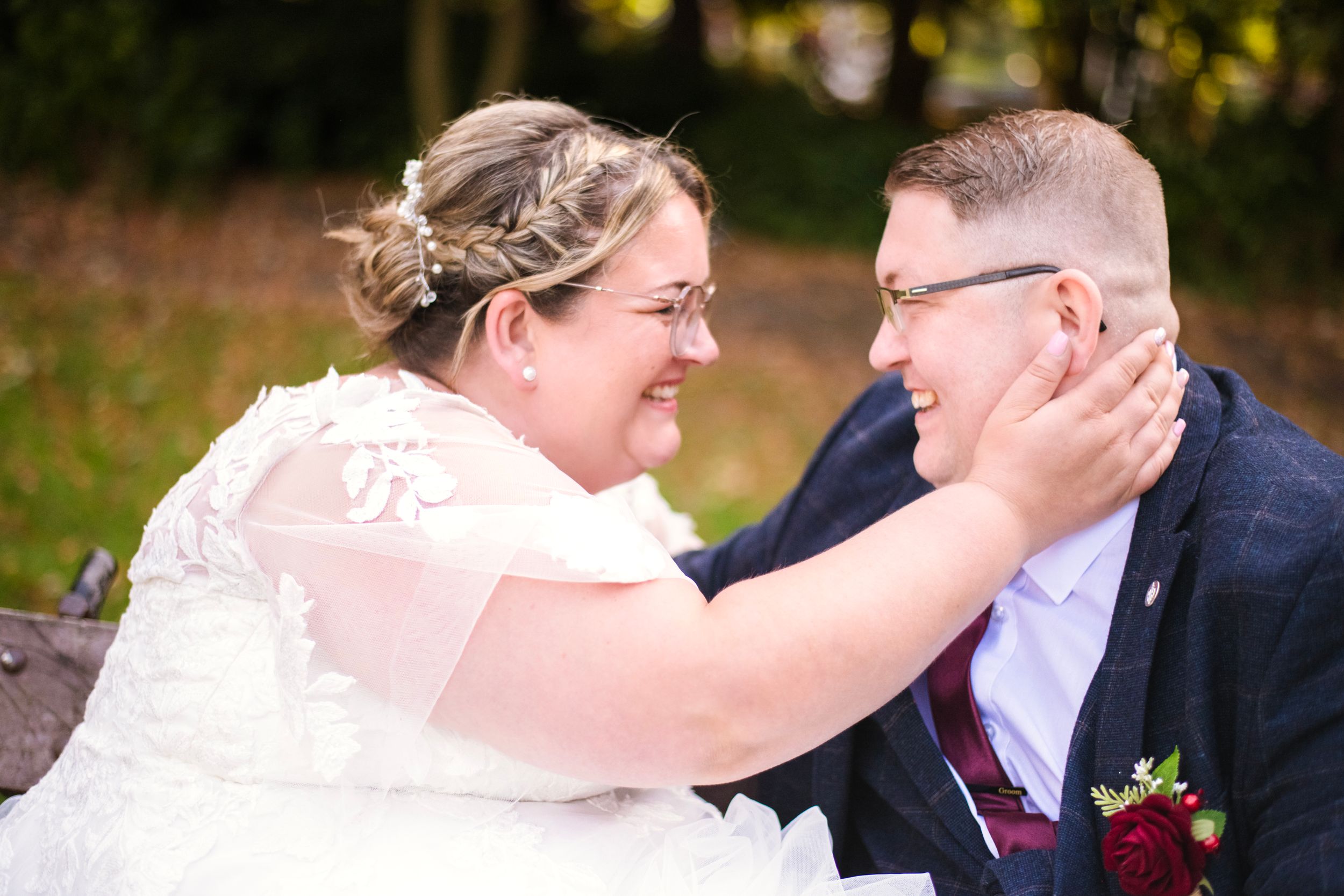Intimate outdoor wedding portrait showing joyful moment between newlyweds.