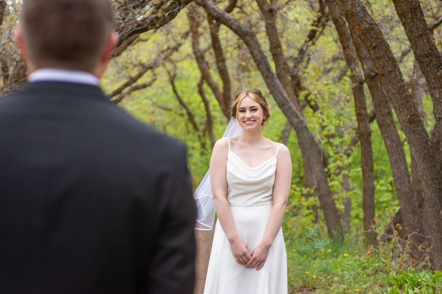 Groom looking at bride at their Salk Lake City garden wedding venue.