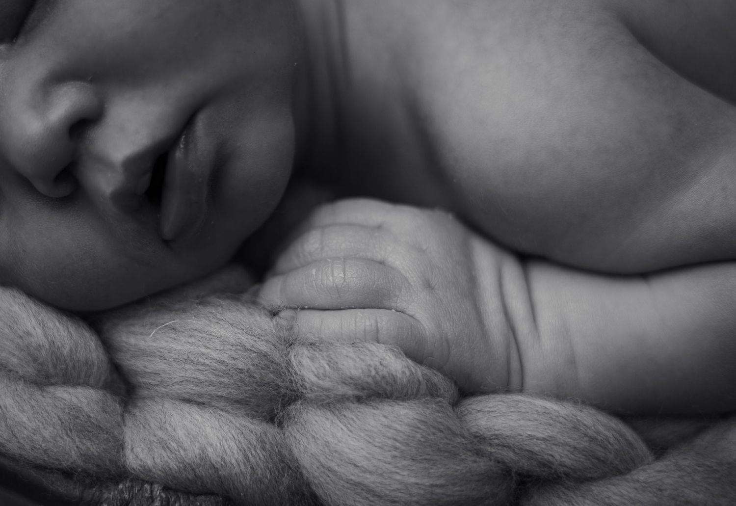 Artistic black and white close-up of newborn baby details.