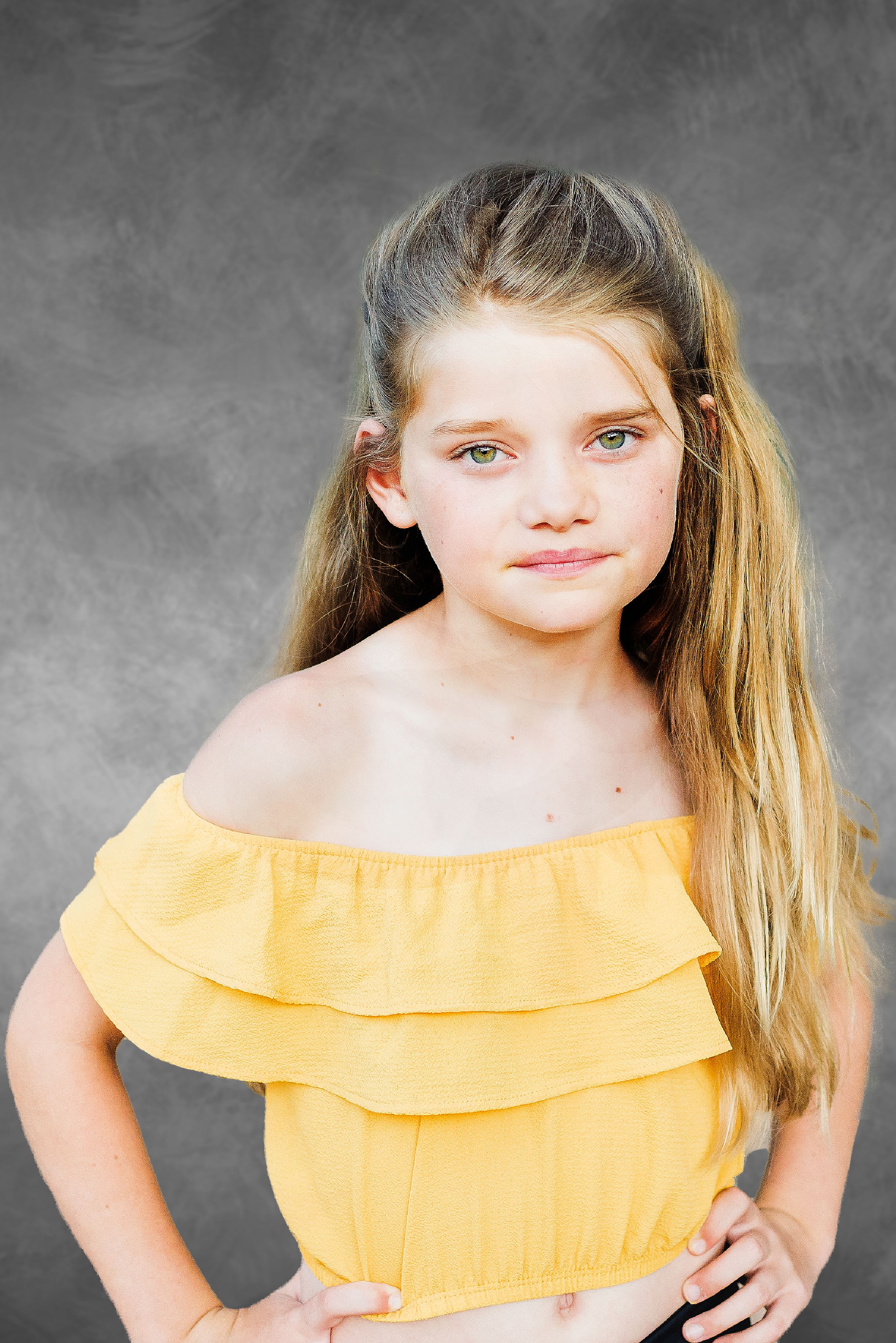Artistic dance photos in yellow and black outfit with gray studio backdrop.