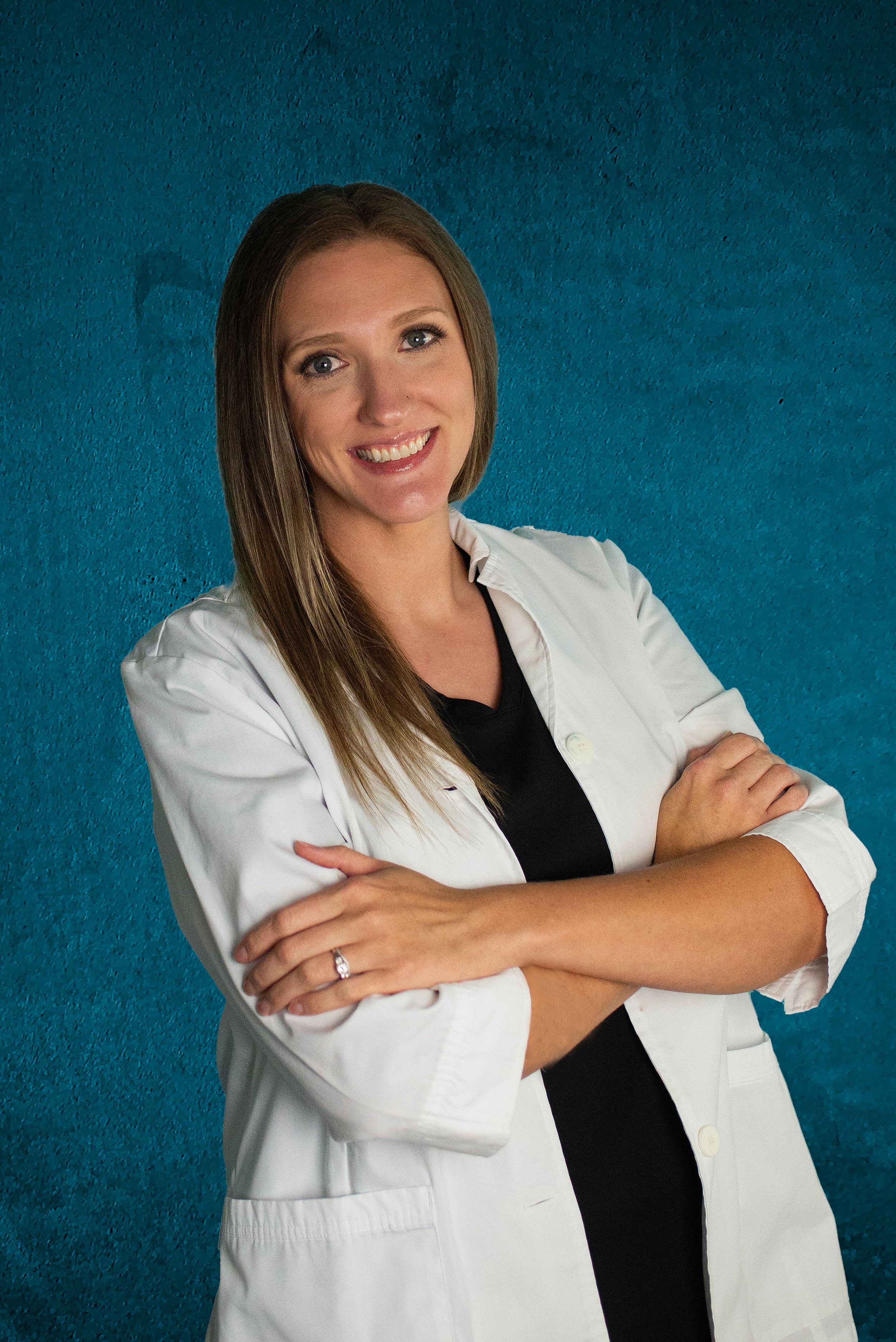 Professional portraits of woman in white lab coat against blue backdrop.