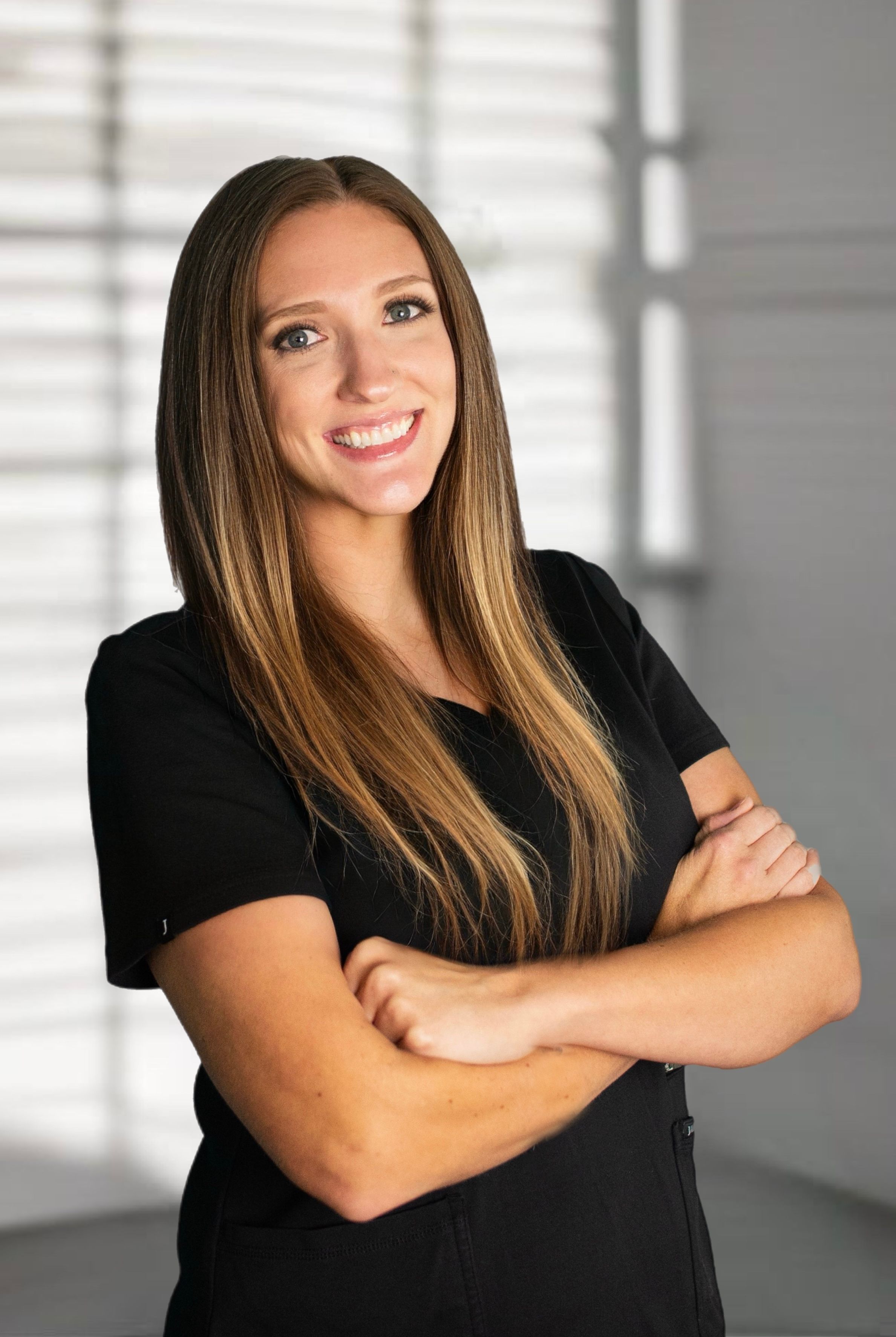 Professional headshots of woman in black shirt against white background with window shadows.