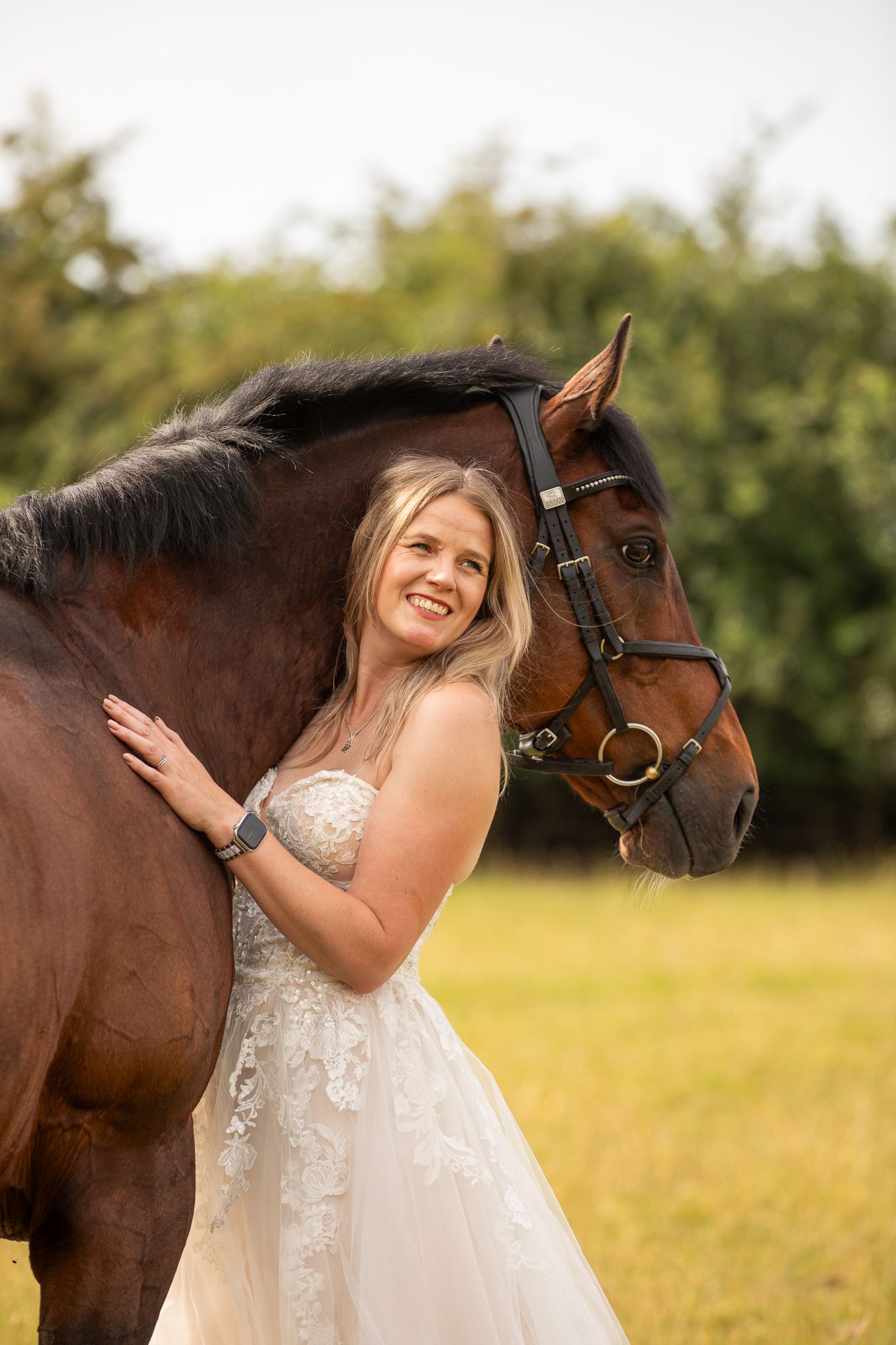 Young equestrian poses with palomino pony in a series of natural outdoor portraits showing their special bond.