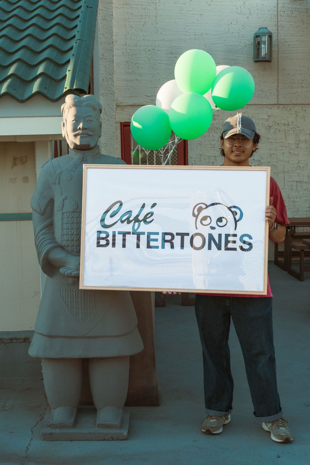 Several connected images show green balloons and business signage including a cafe with a panda logo and Bittertones text.