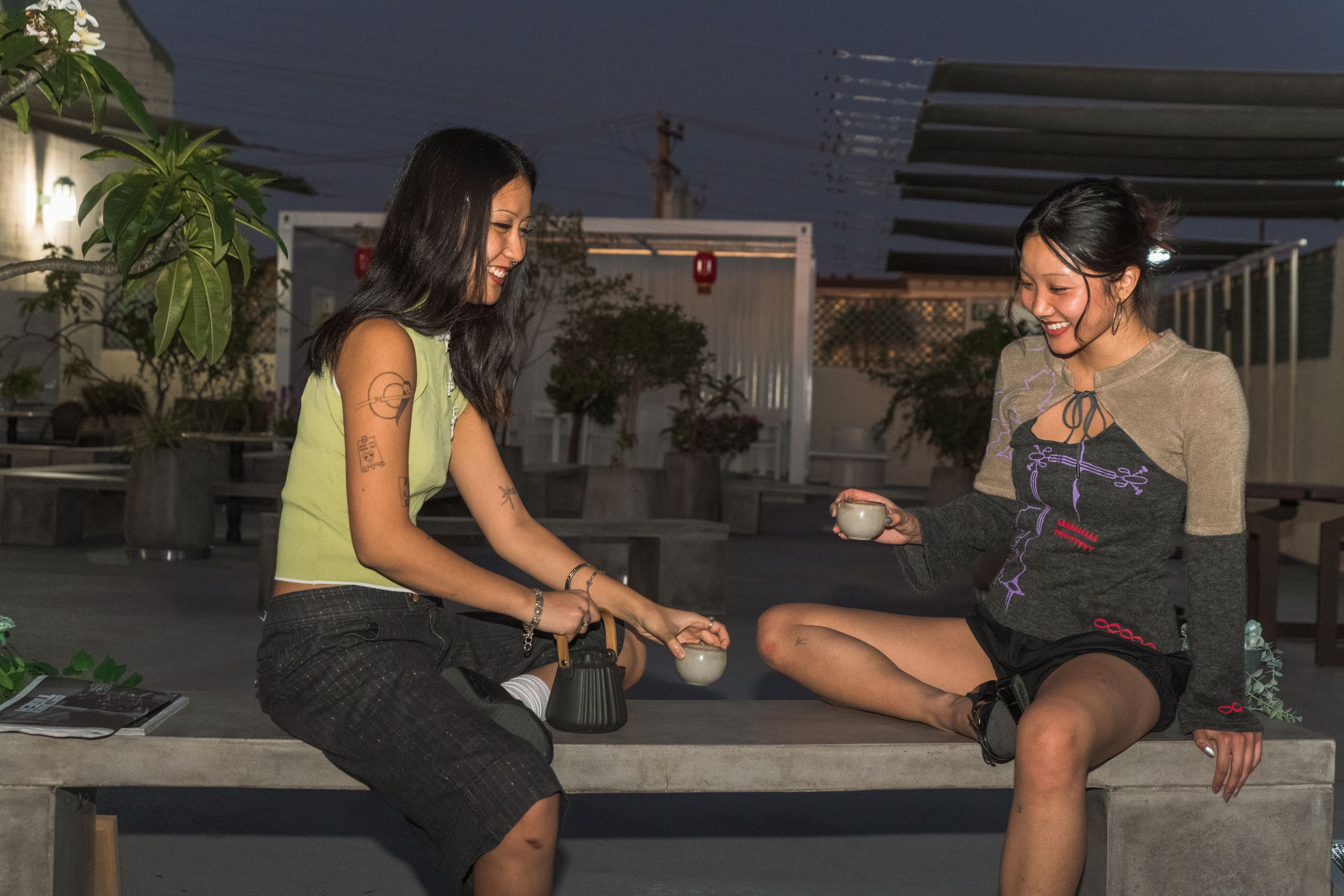 Friends enjoy socializing and playing board games at night in an outdoor setting.