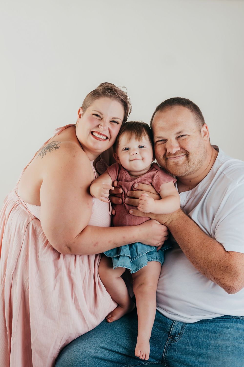 A heartwarming series of four candid family photos showing tender moments together in matching light outfits.
