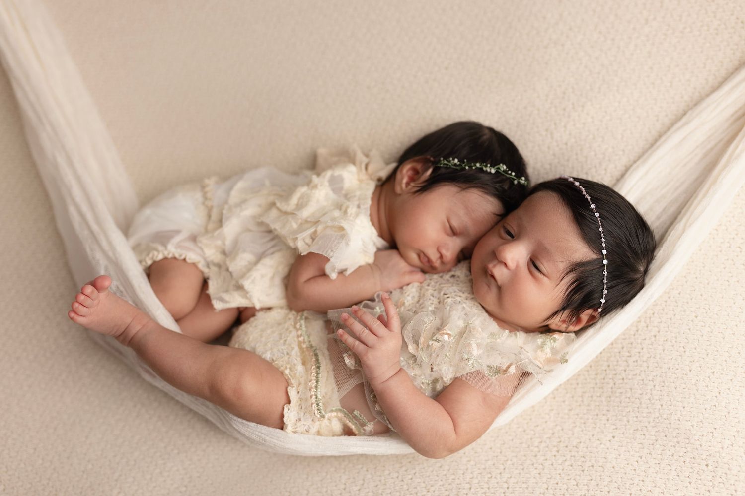 twins in matching cream dresses