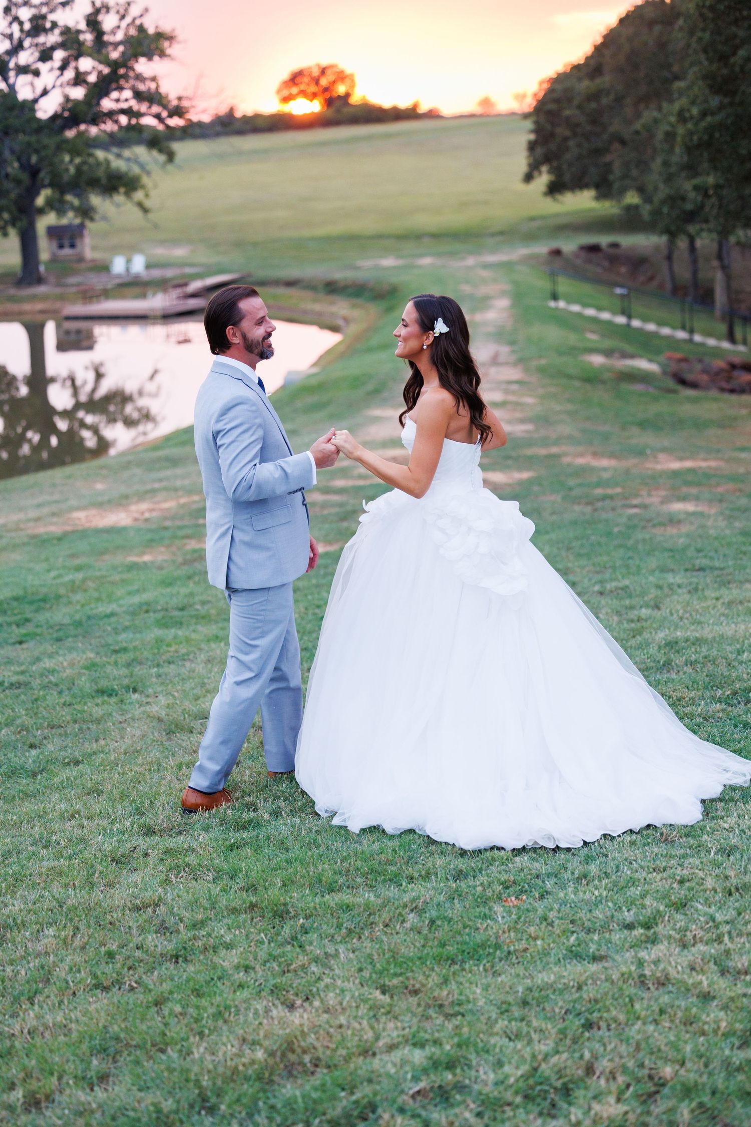 A romantic proposal moment takes place on a garden pathway surrounded by reflecting pools and manicured landscaping.
