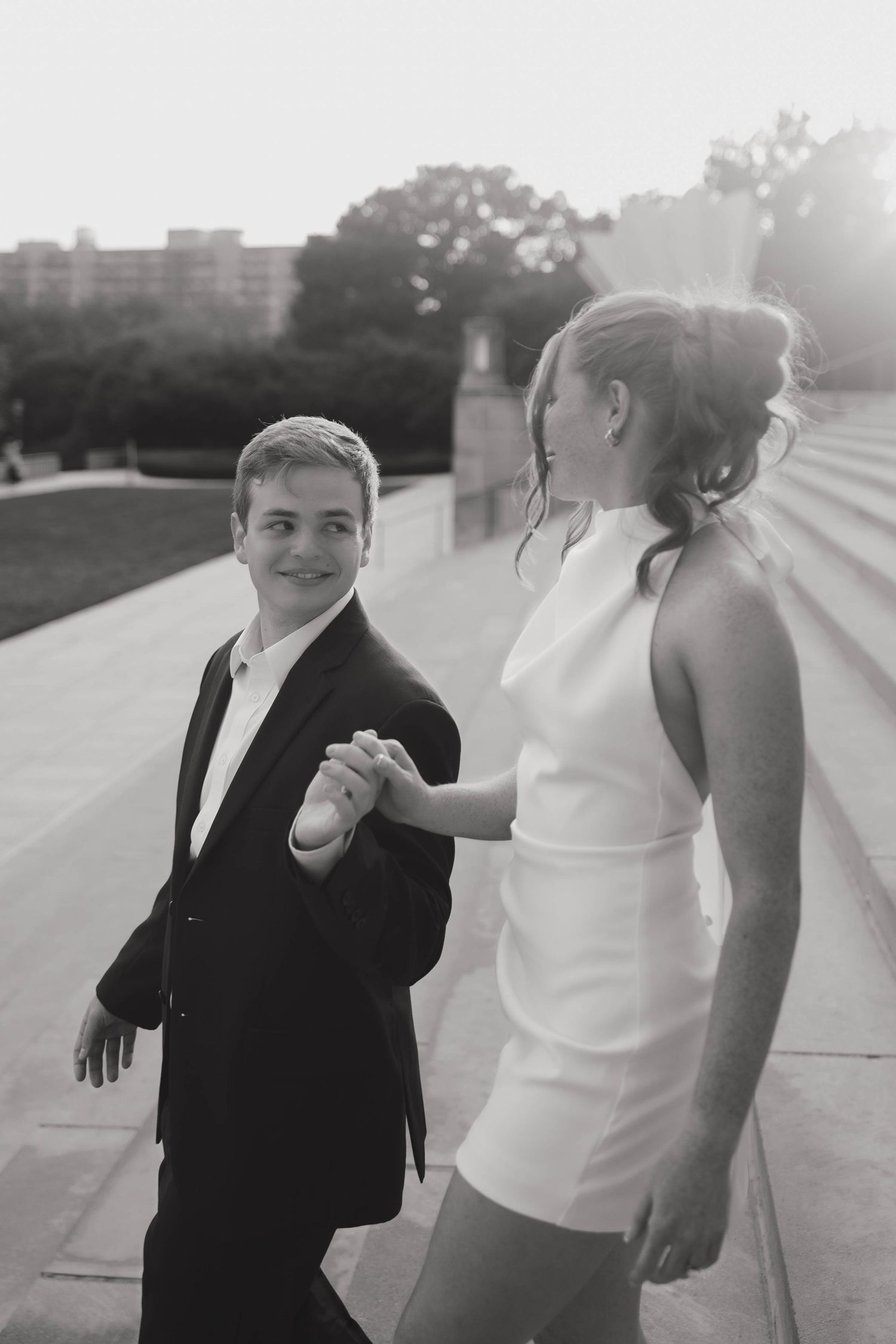 A romantic black and white photo series showing a couple interacting playfully outdoors.