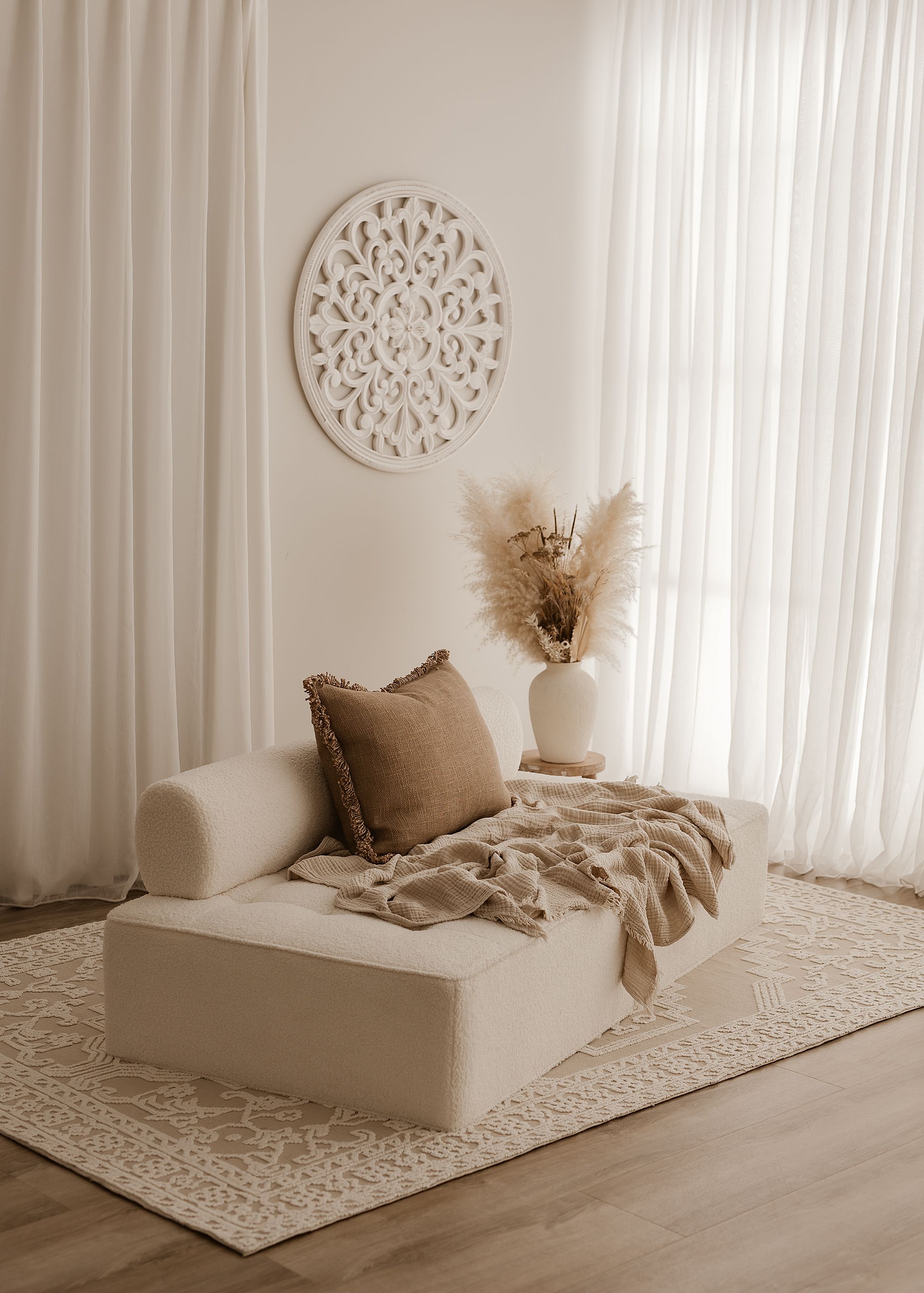 Six progressive images show beige minimalist bedding sets displayed on white carpets with decorative wall art.