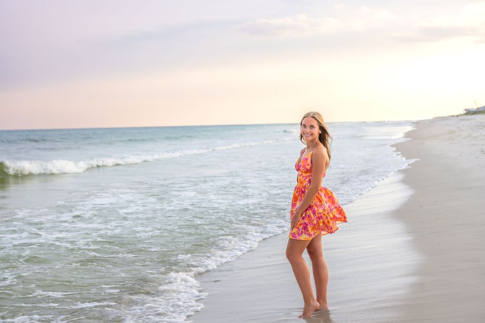 Candid beach photography capturing carefree moments along the water's edge during golden hour.