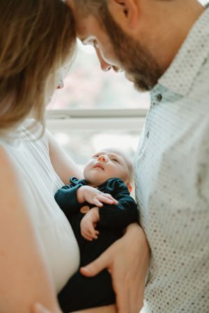 Series of intimate bonding moments captured in soft natural window light.