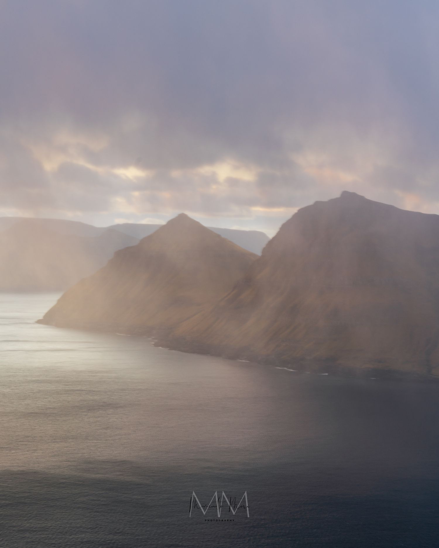 Moody scene along the Faroe Islands coast as fog rolls in.