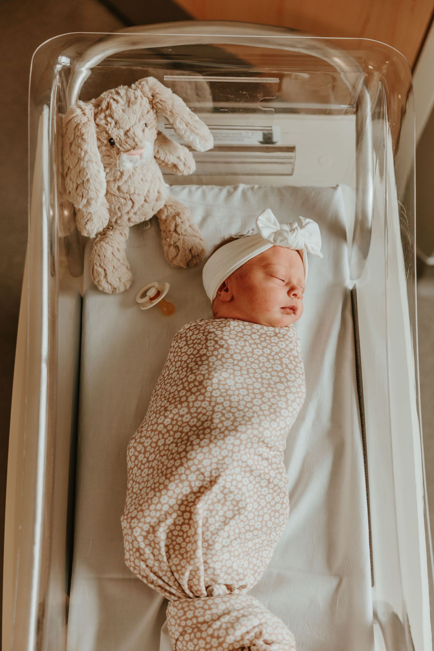 A baby receives medical attention while lying on a changing table or medical examination surface.