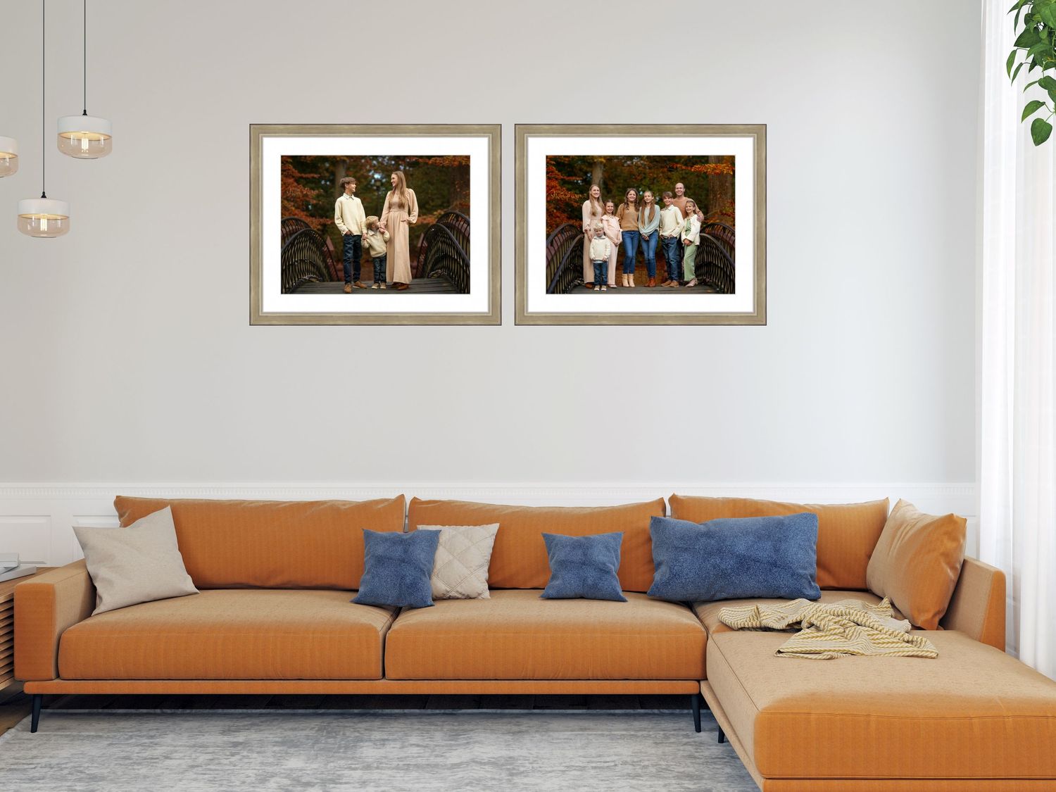 Modern living room interior featuring a tan leather sectional sofa with blue accent pillows and framed artwork.