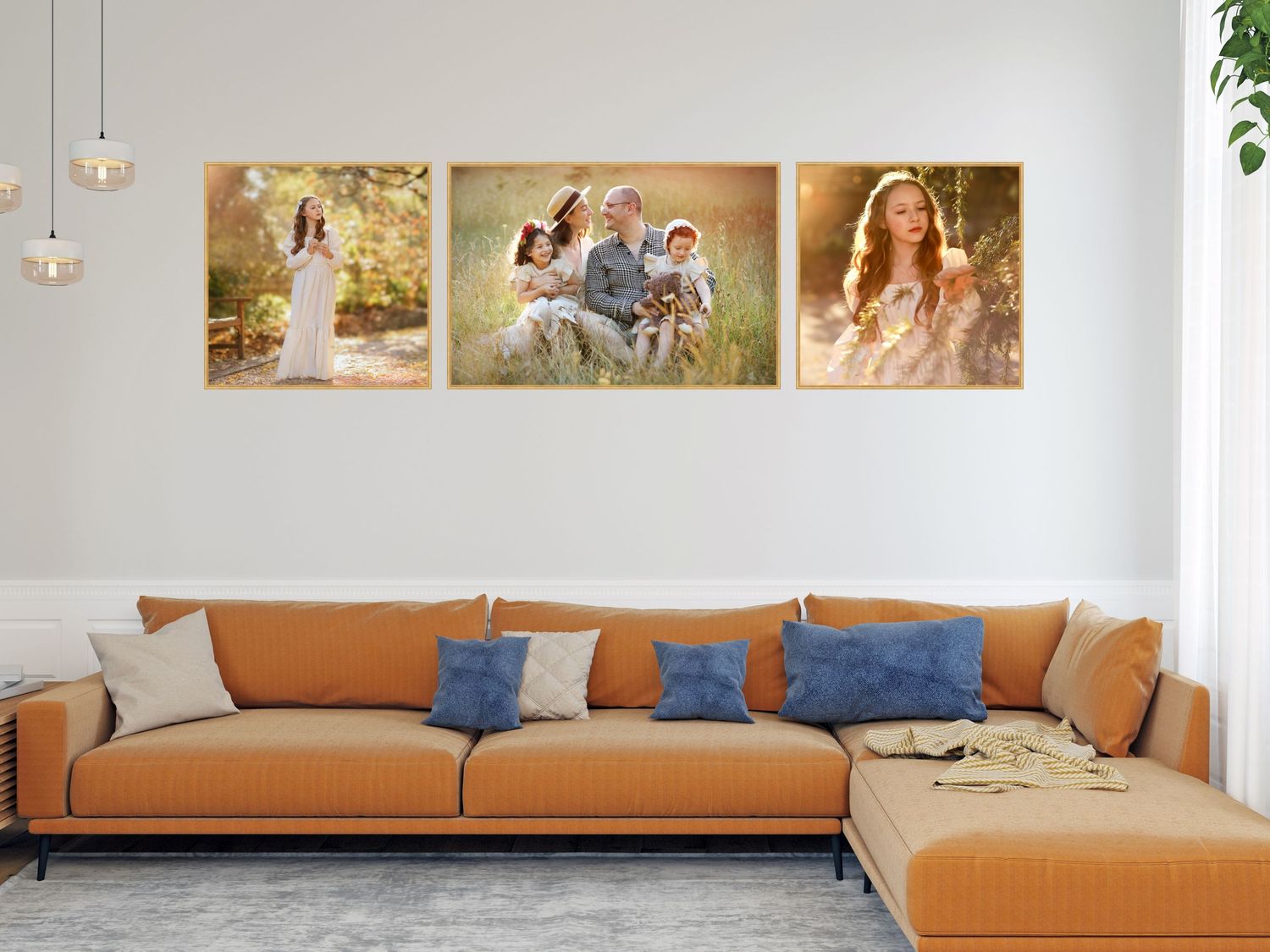 Canvas prints displayed above an orange sectional sofa with blue throw pillows in a modern living room setting.